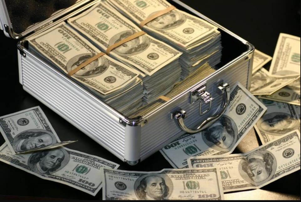 Financial Implications hearing loss suitcase full of $100 dollar bills